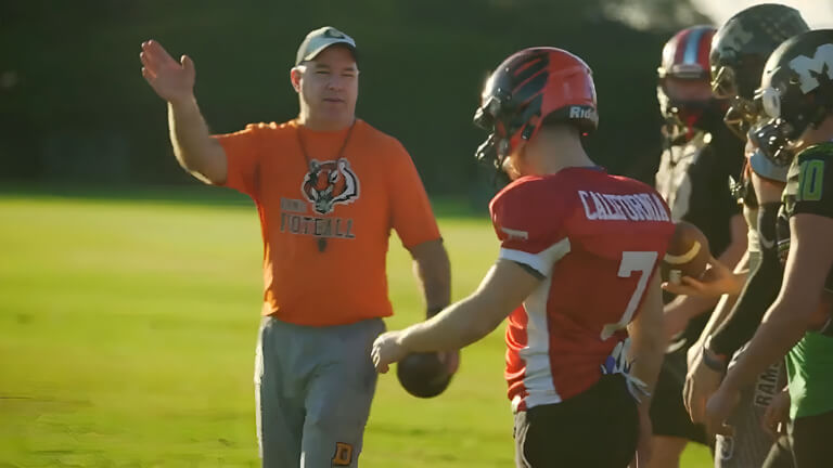 Hawaii Tiki Bowl Coach with Football Players at Practice